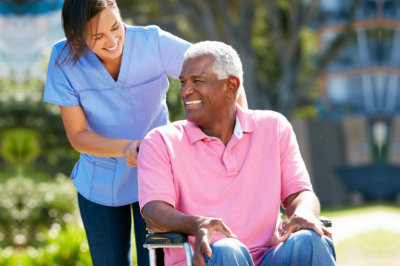 (Rosewood Home Care) caregiver pushing senior man in wheelchair