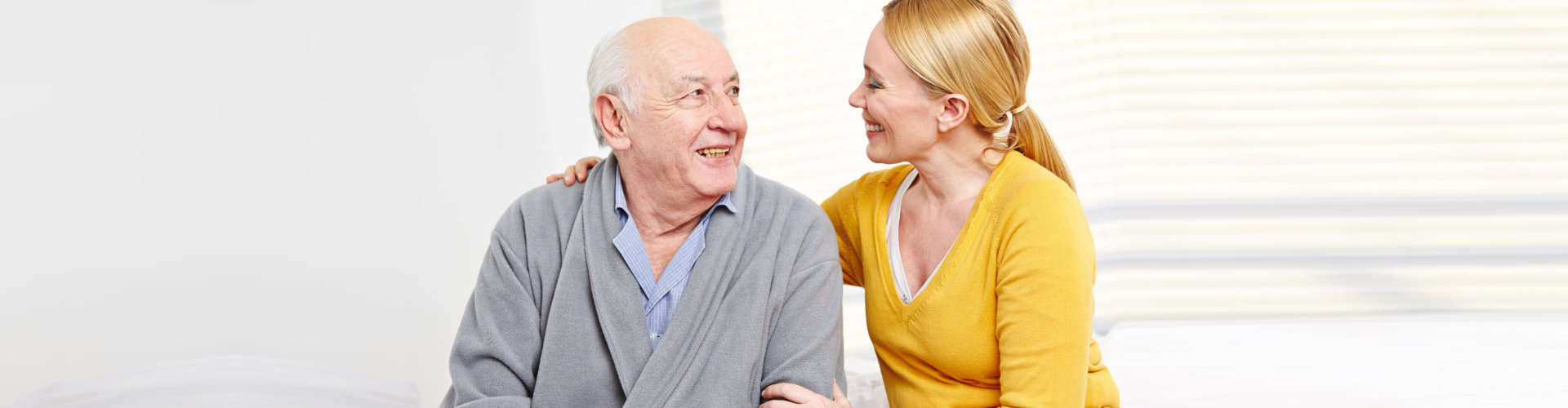 woman and old man in retirement home smiling