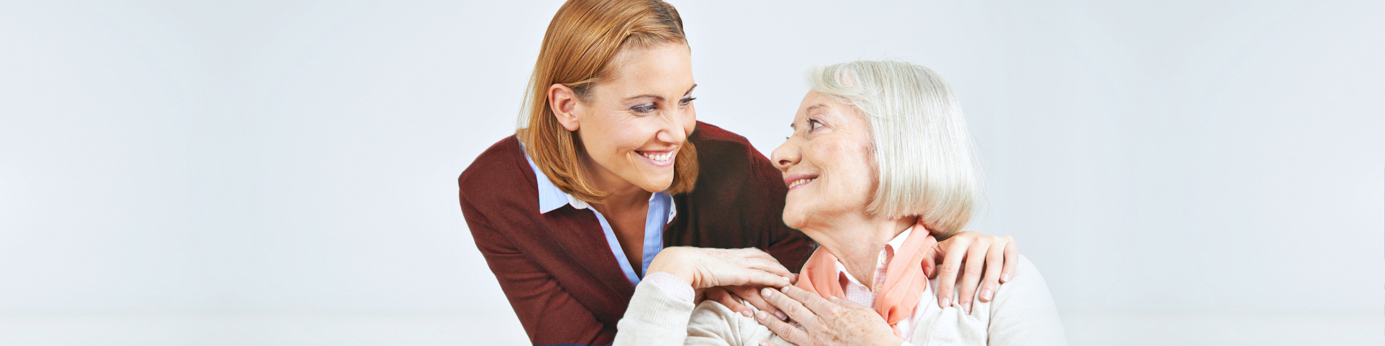 (Rosewood Home Care)caregiver and senior woman smiling to each other